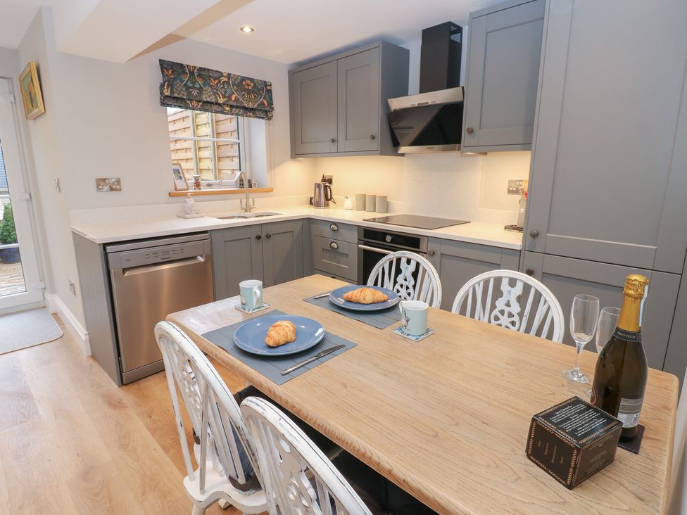 A kitchen with a table and chairs at Brooklyn Cottage in Kirkby Malzeard