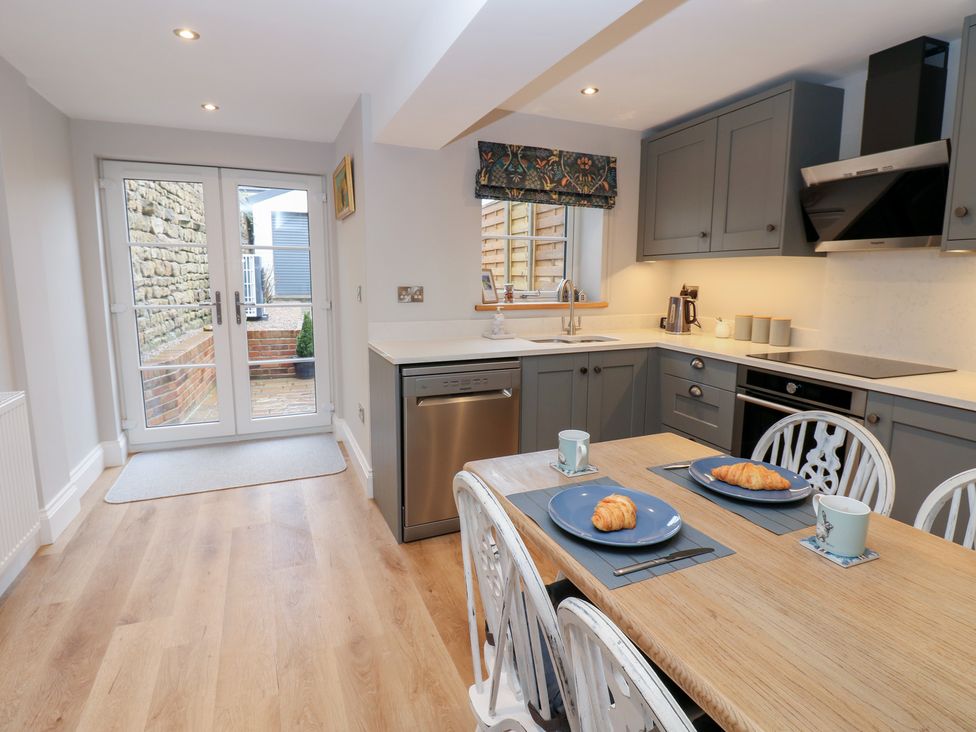 A kitchen with a table and chairs at Brooklyn Cottage in Kirkby Malzeard
