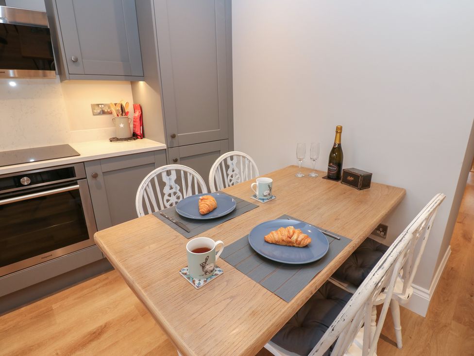 A dining room with a table and chairs at Brooklyn Cottage in Kirkby Malzeard