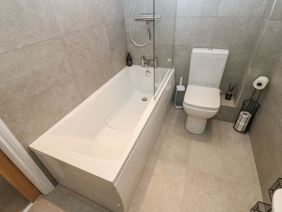 A bathroom with a bathtub and toilet at Brooklyn Cottage, Kirkby Malzeard