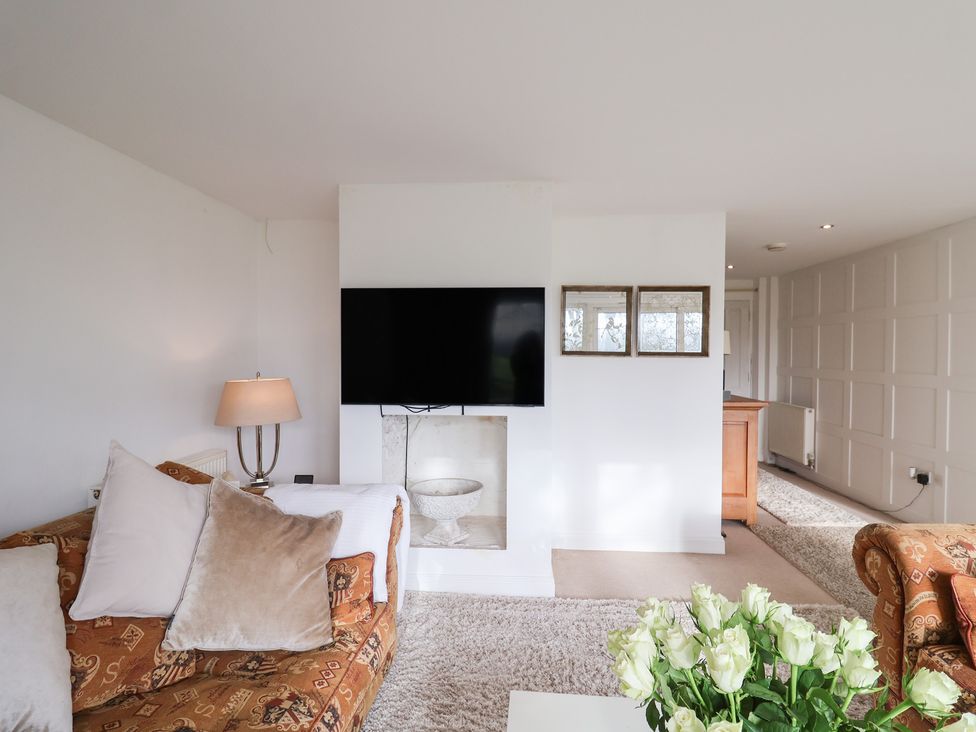 A living room with a television and a sofa at Three Ways South Lopham near Garboldisham
