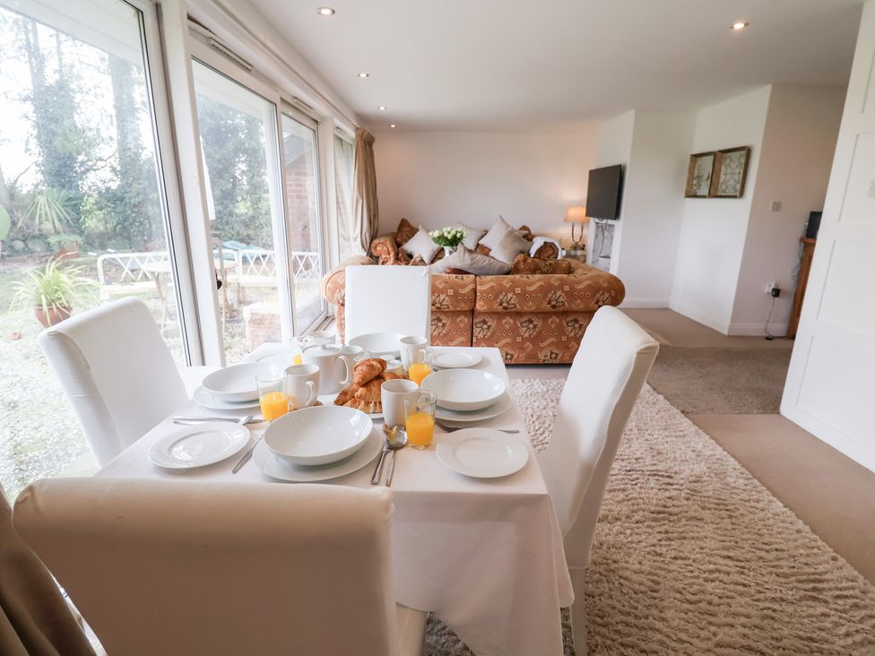 A dining table set with plates and drinks at Three Ways South Lopham near Garboldisham