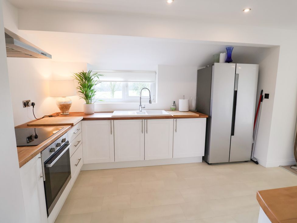 A kitchen with a sink and refrigerator at Three Ways South Lopham near Garboldisham