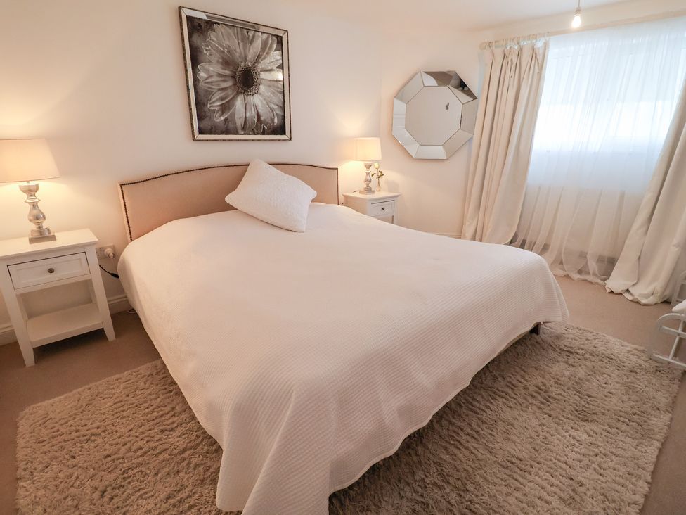 A bedroom with a bed and nightstands at Three Ways in South Lopham near Garboldisham