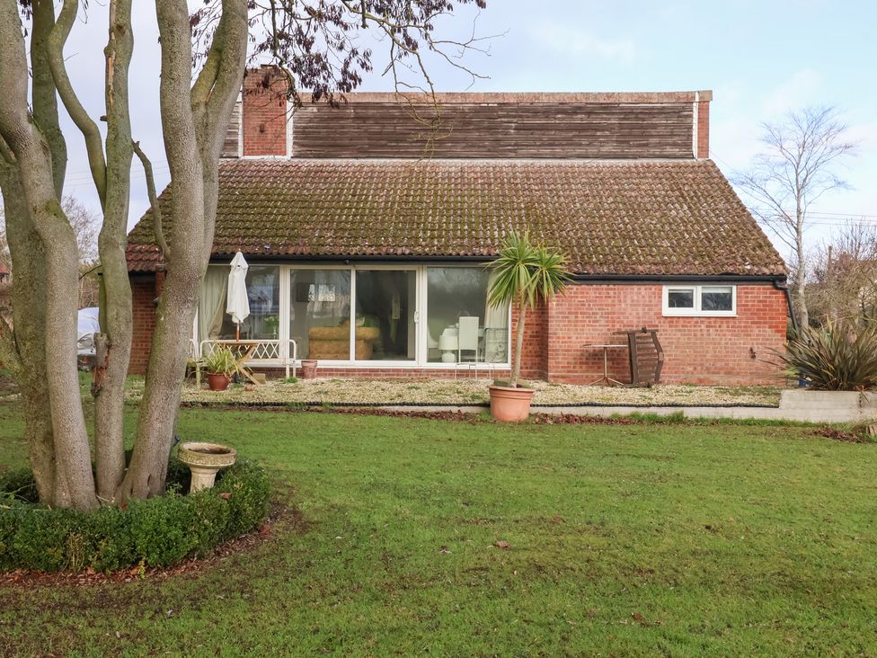 A house with a garden and trees at Three Ways in South Lopham near Garboldisham