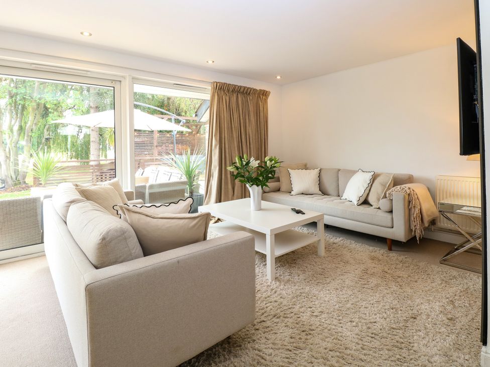 A living room with sofas, a coffee table, and a television at Three Ways South Lopham near Garboldisham