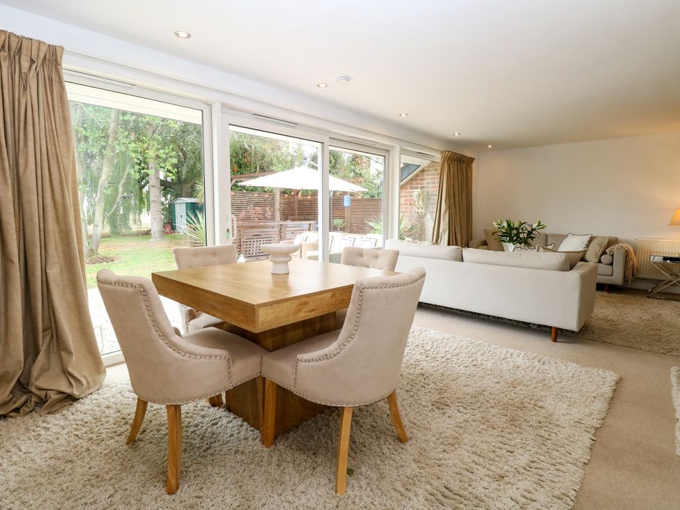 A dining area with a table and chairs at Three Ways in South Lopham near Garboldisham