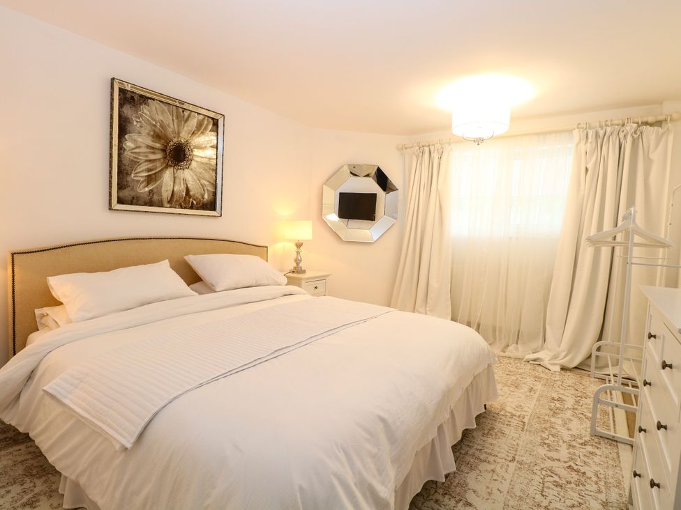 A bedroom with a bed and nightstand at Three Ways South Lopham near Garboldisham