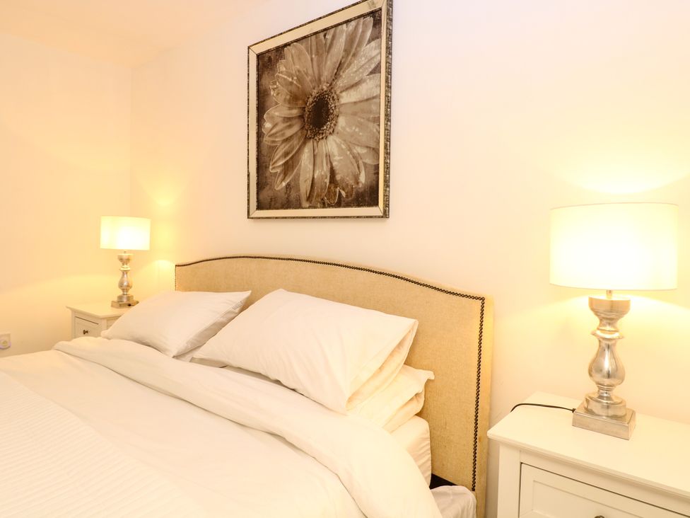A bedroom with a bed and bedside tables at Three Ways South Lopham near Garboldisham