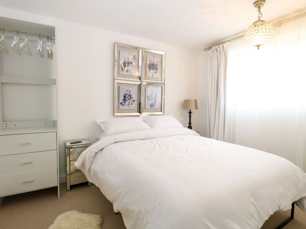 A bedroom with a bed and wardrobe at Three Ways South Lopham near Garboldisham