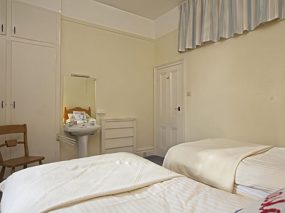 A bedroom with two beds and a sink at 4 Ringrone Salcombe