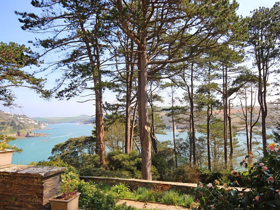 A view of a coast with trees and water at 4 Ringrone Salcombe