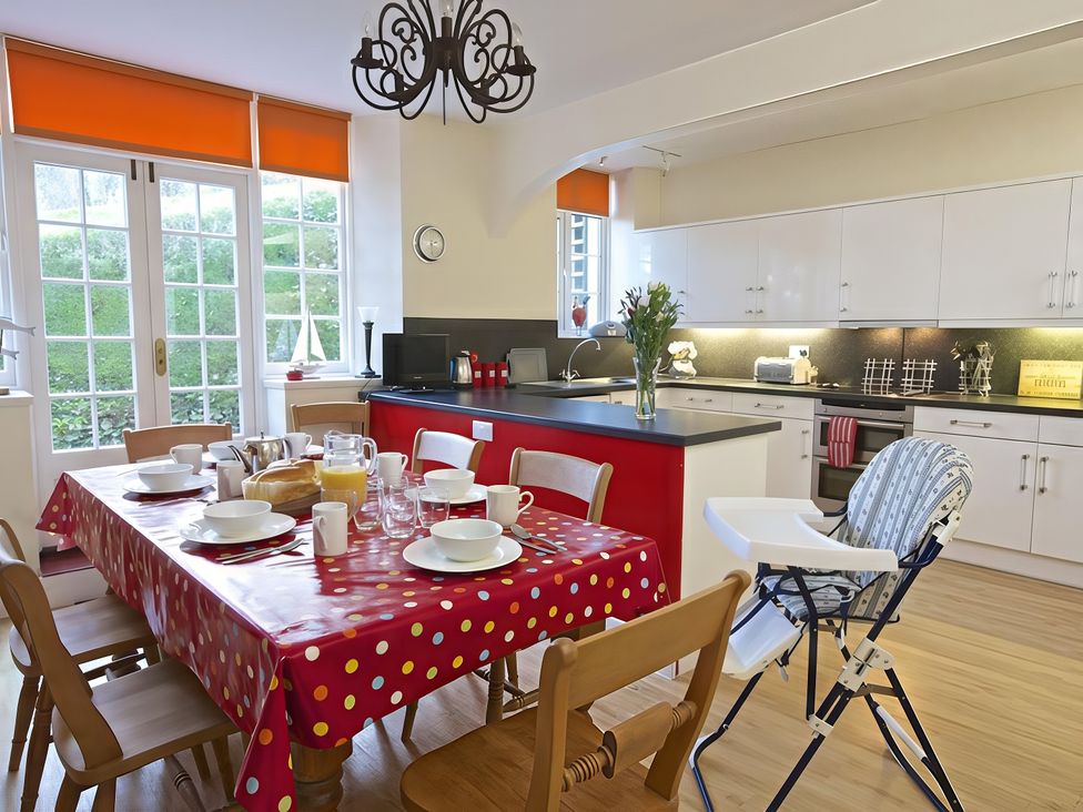 A kitchen with a dining table set for breakfast at 4 Ringrone in Salcombe