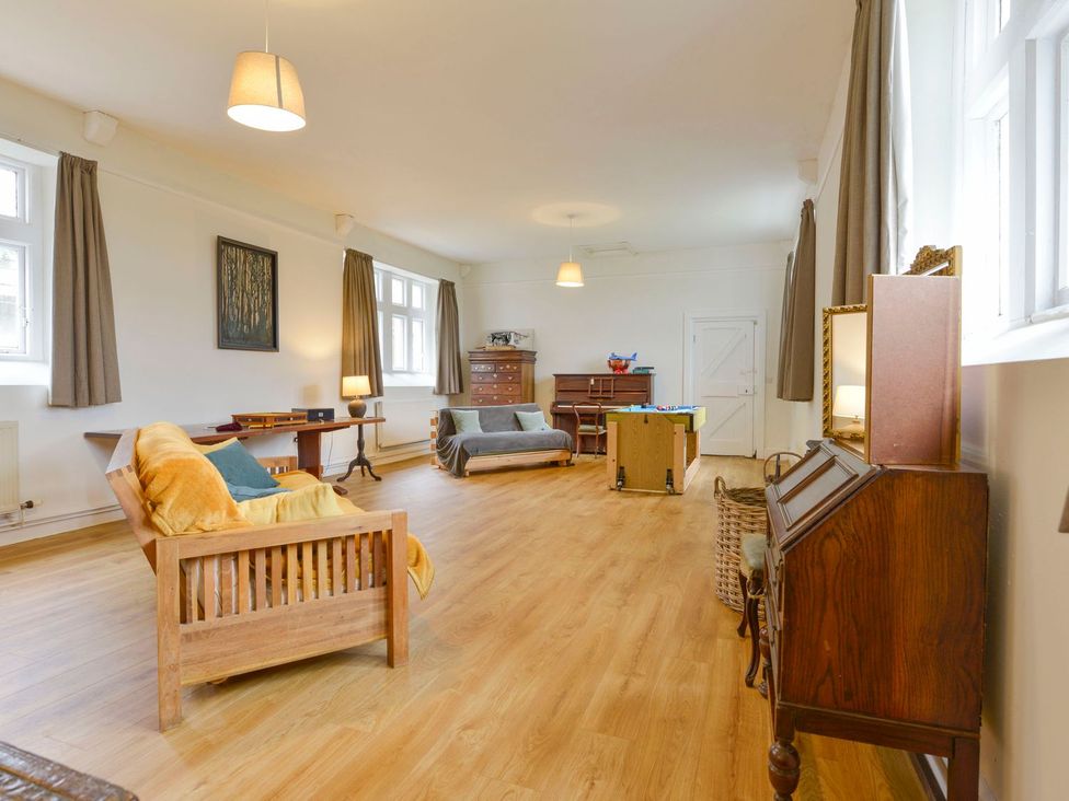 A living room with sofas and a table at School House in Ivybridge