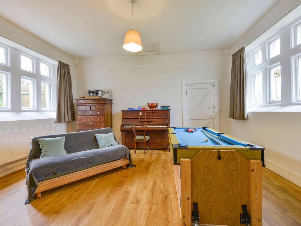 A recreation room with a pool table and piano at School House in Ivybridge