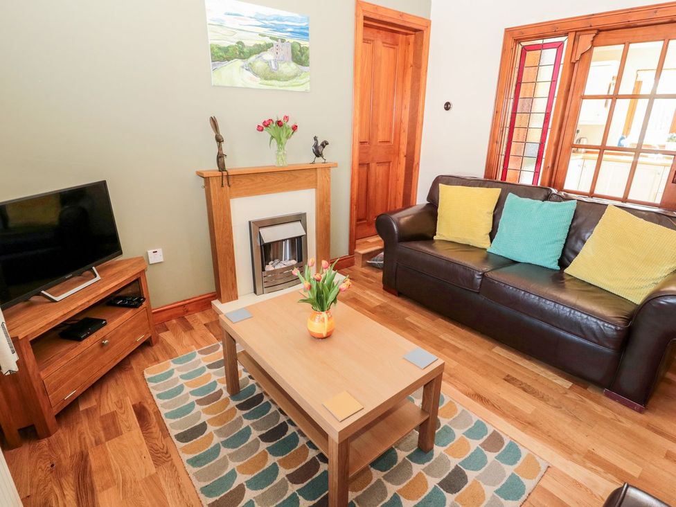 A living room with a sofa and coffee table at Cygnet Cottage, Berwick-upon-Tweed