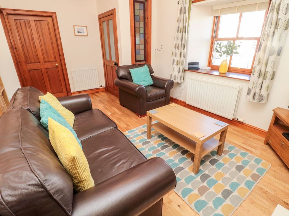 A living room with a sofa and coffee table at Cygnet Cottage Berwick-upon-Tweed