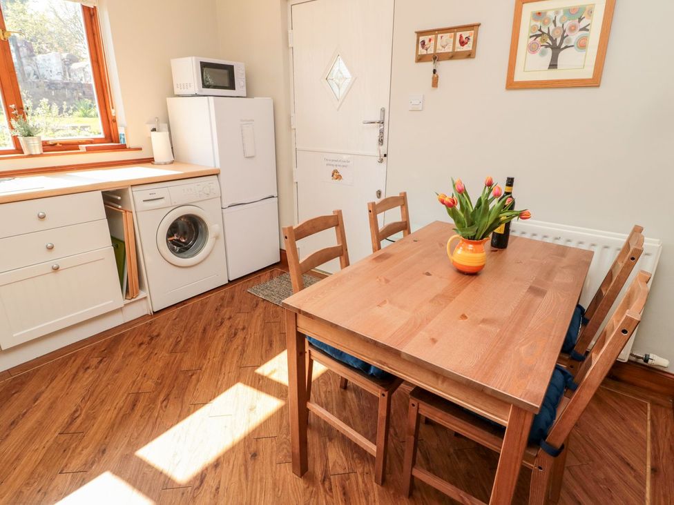 A kitchen with a table and chairs at Cygnet Cottage Berwick-upon-Tweed