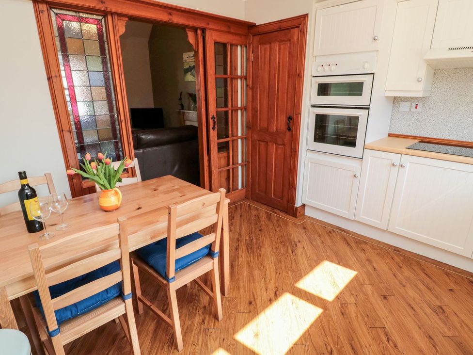 A kitchen with a dining table and chairs at Cygnet Cottage Berwick-upon-Tweed