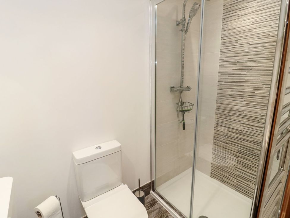 A bathroom with a shower and toilet at Cygnet Cottage Berwick-upon-Tweed