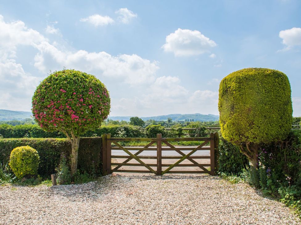 An outdoor area with a gate and topiary at Glencoe Cottage in Broadway