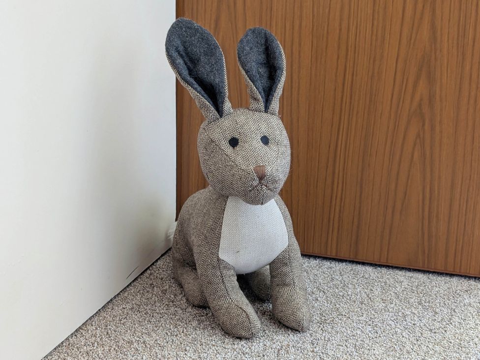 A stuffed rabbit next to a door at Roslyn in Romsey