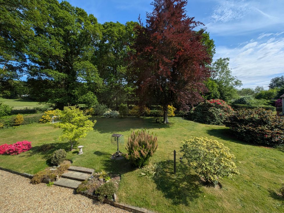 A garden with various trees and flower beds at Roslyn in Romsey