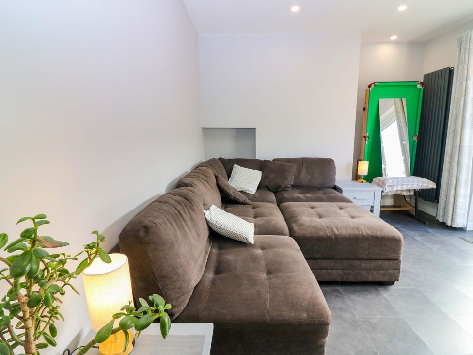 A living room with a sofa and lamp at The Harbour Hoose Stonehaven