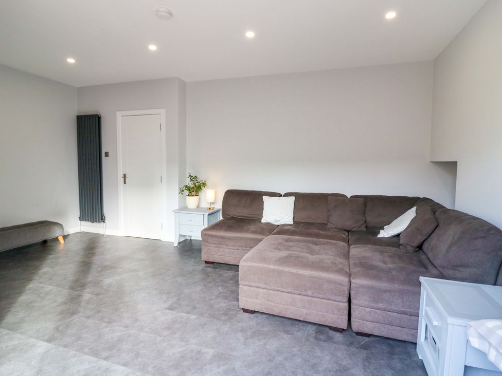 A living room with a sofa and a table at The Harbour Hoose Stonehaven