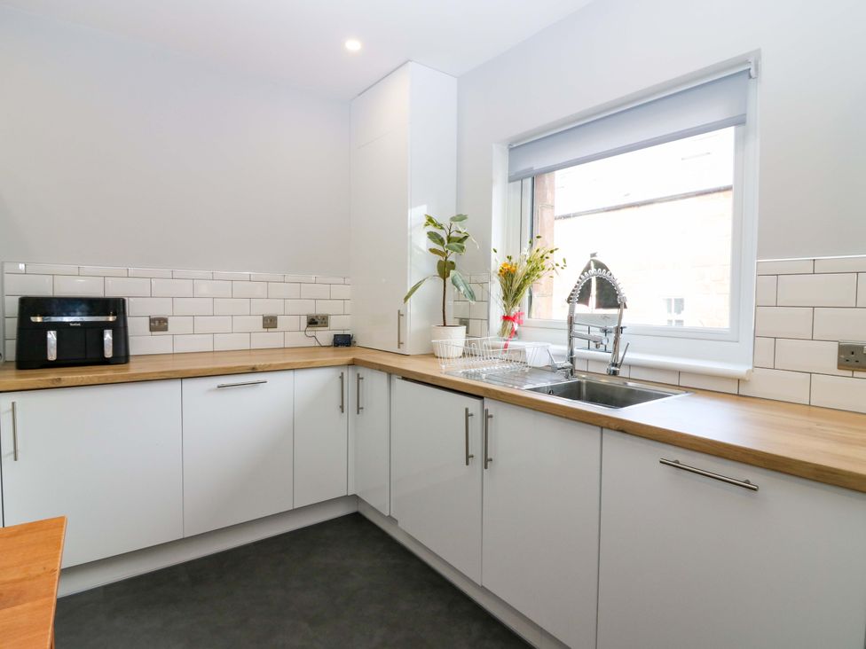 A kitchen with a sink and counter at The Harbour Hoose Stonehaven