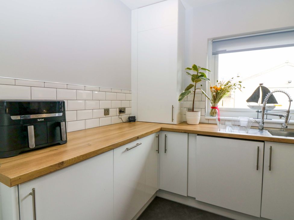 A kitchen with a sink and a plant at The Harbour Hoose Stonehaven