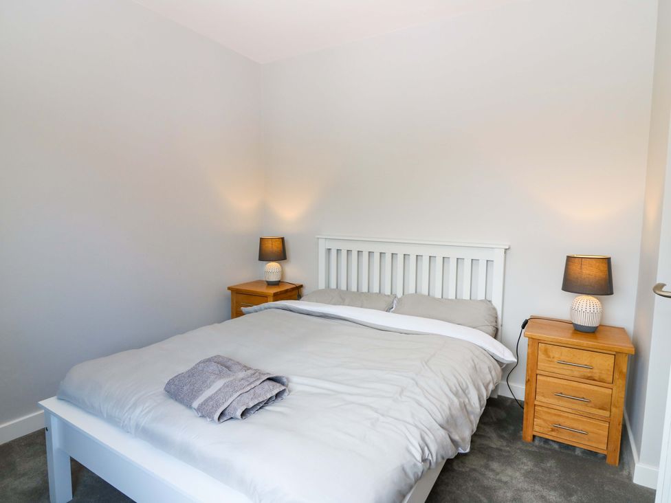 A bedroom with a bed and nightstands at The Harbour Hoose Stonehaven