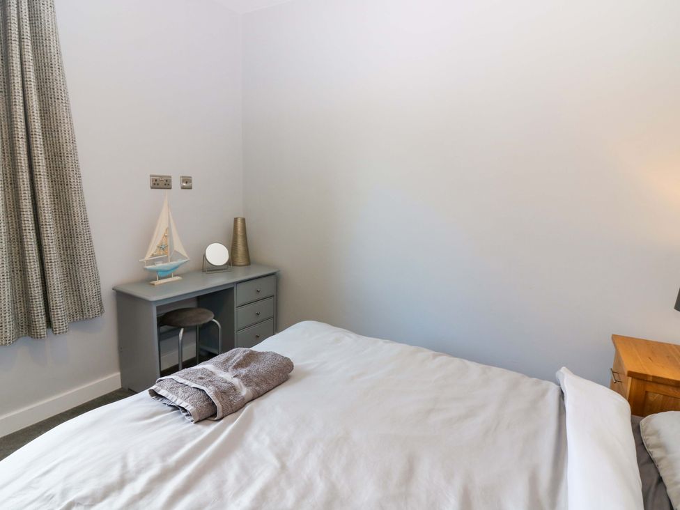 A bedroom with a bed and a desk at The Harbour Hoose Stonehaven