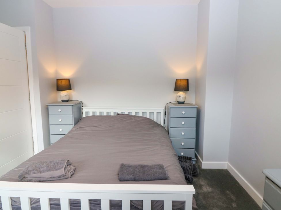A bedroom with a bed and bedside lamps at The Harbour Hoose Stonehaven
