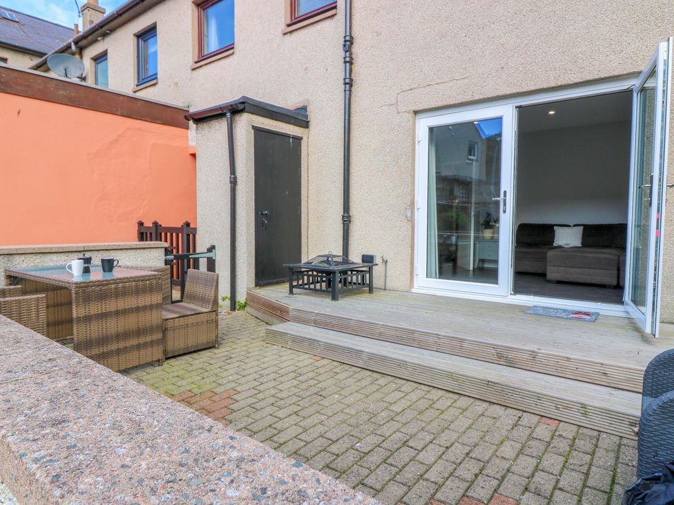 An outdoor patio area with furniture and doors at The Harbour Hoose Stonehaven