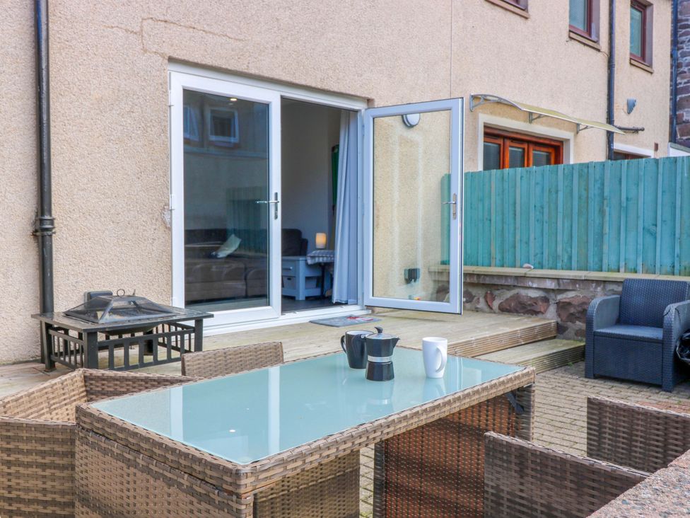 An outdoor seating area with a table and cups at The Harbour Hoose Stonehaven