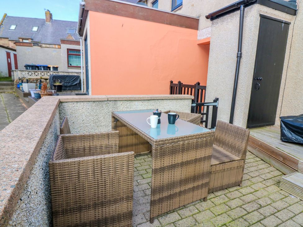 A table with chairs and mugs in an outdoor area at The Harbour Hoose Stonehaven
