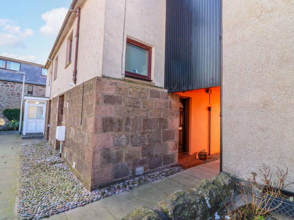 The entrance area of a property with stone walls and a door at The Harbour Hoose Stonehaven