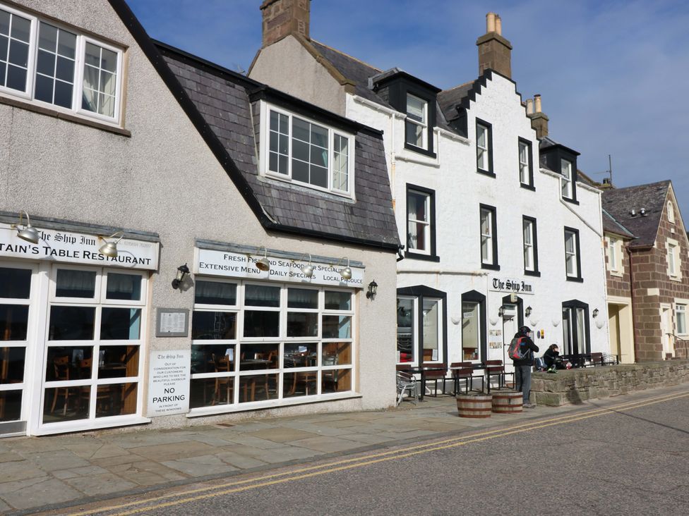 An outdoor view of The Ship Inn restaurant with seating at The Harbour Hoose Stonehaven