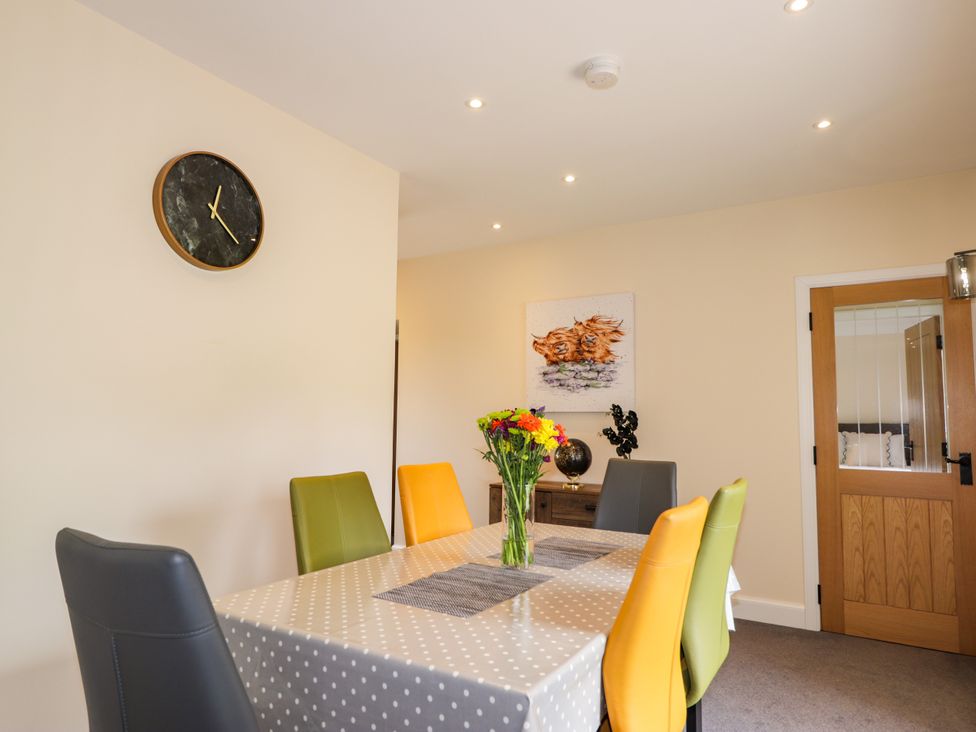 A dining room with a table and chairs at Millmoss Cottage 