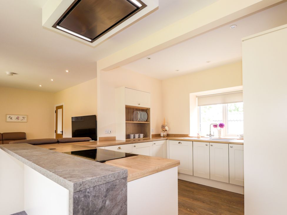 A kitchen with cabinets and countertop at Millmoss Cottage