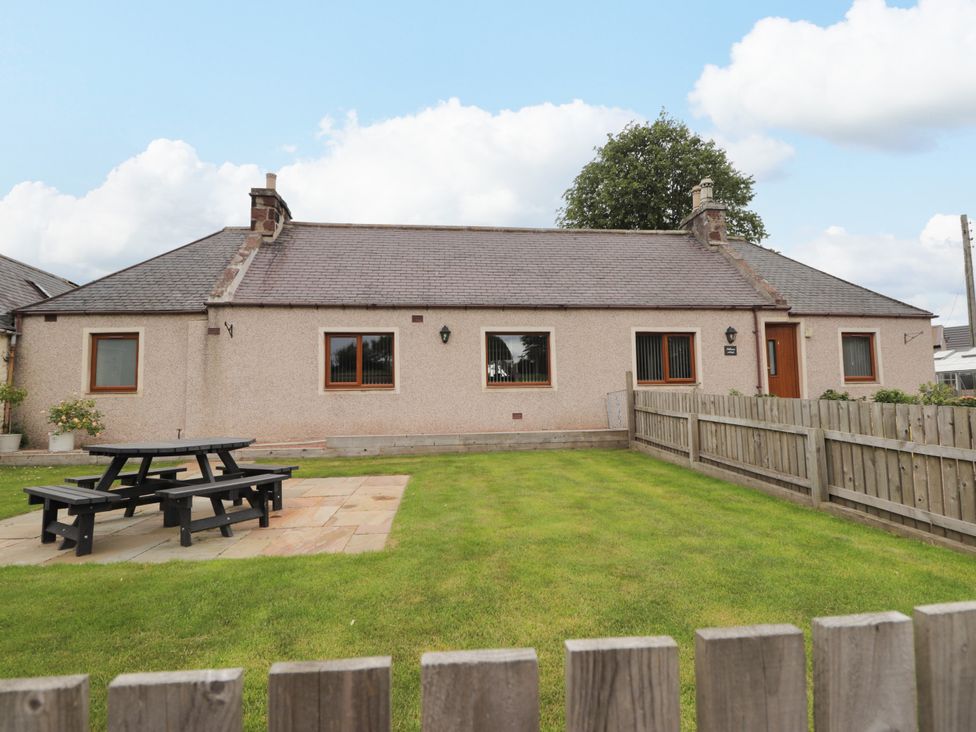A house with a garden and outdoor seating at Millmoss Cottage in 