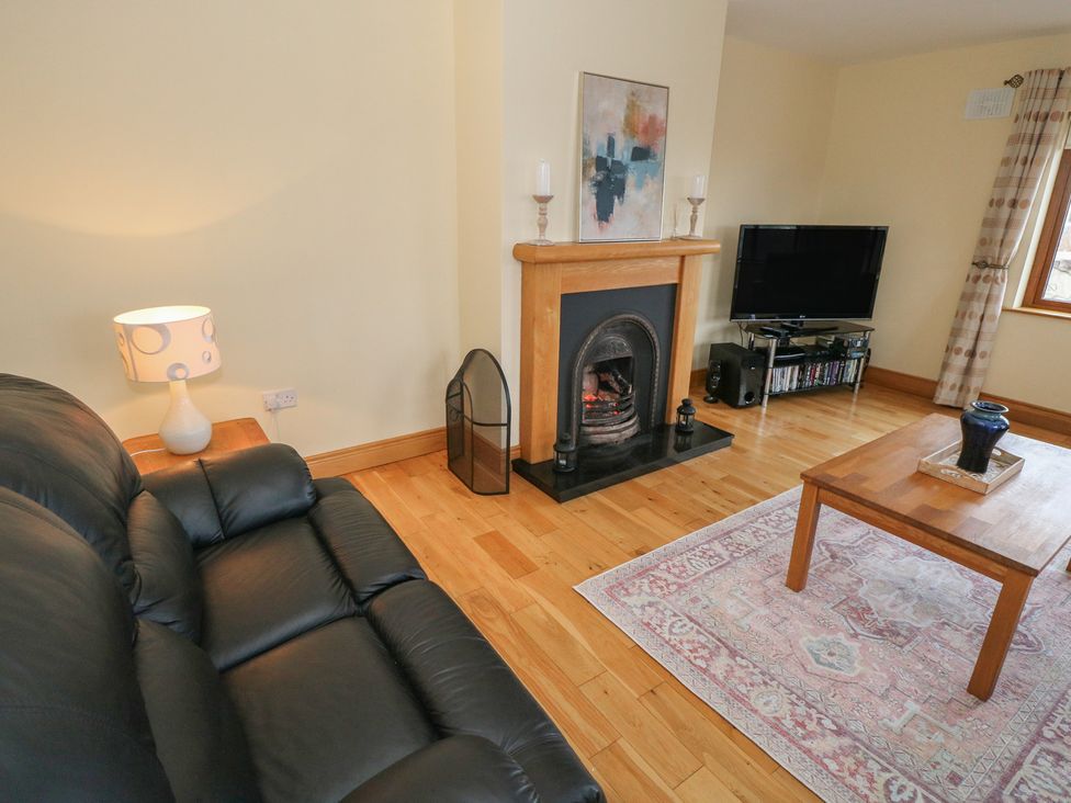 A living room with a sofa and fireplace at Tigh Marie