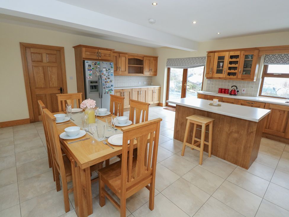 A kitchen with a dining table and chairs at Tigh Marie