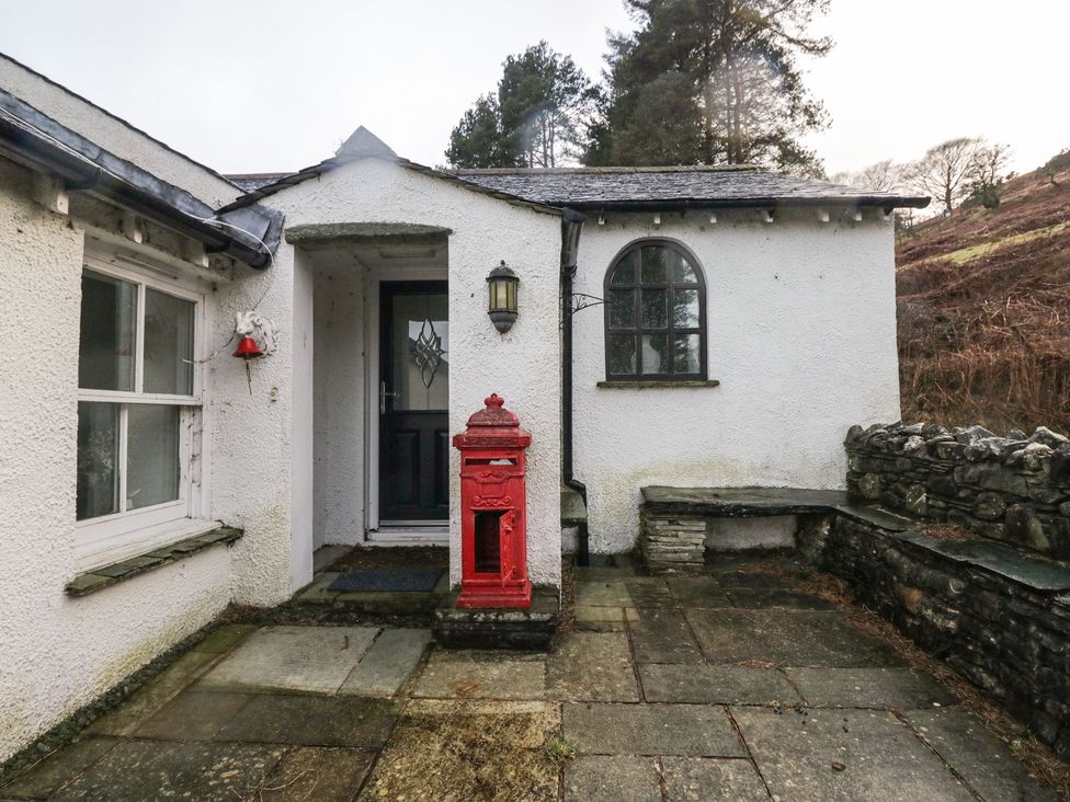 An entrance with a red post box and stone wall at Newlands Fell House near Keswick