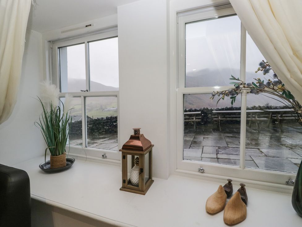 A window with a plant and lantern at Newlands Fell House in Newlands near Keswick
