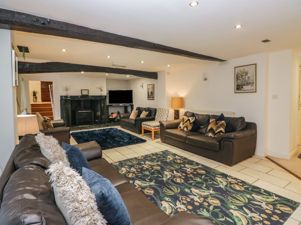 A living room with sofas and a fireplace at Newlands Fell House near Keswick