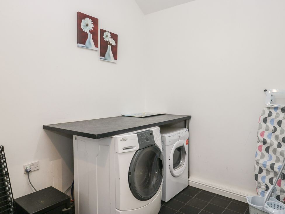 A laundry room with a washing machine and dryer at Newlands Fell House in Newlands near Keswick