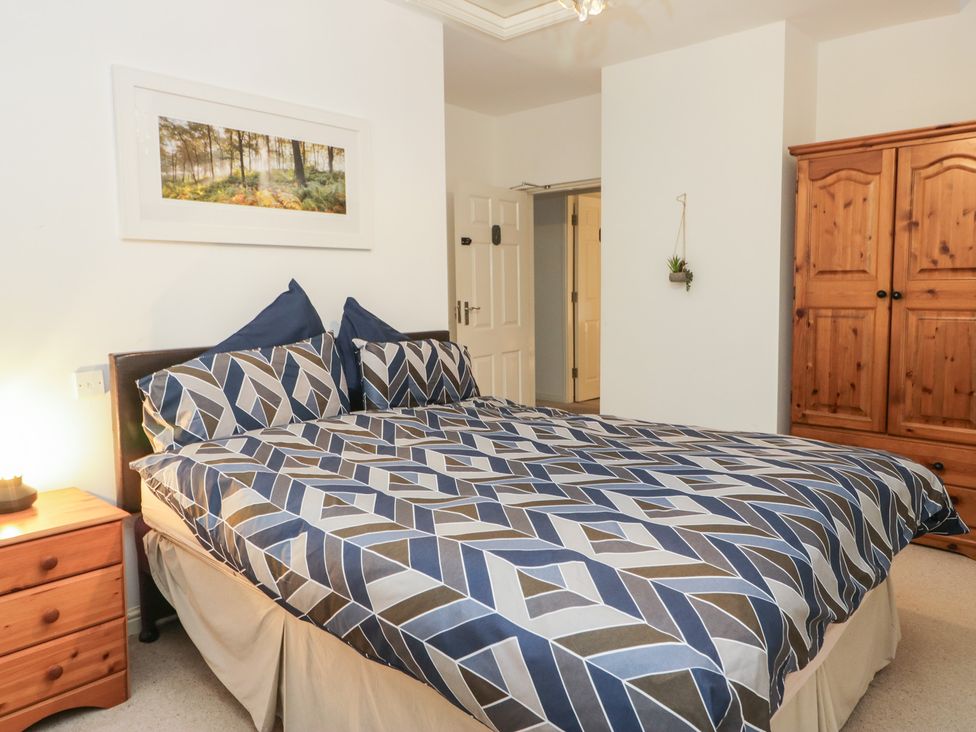 A bedroom with a bed and wardrobe at Newlands Fell House in Newlands near Keswick