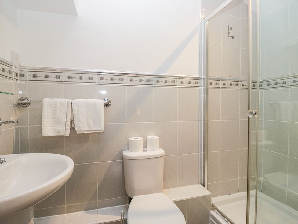 A bathroom with a sink, toilet, and shower at Newlands Fell House in Newlands near Keswick